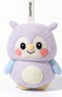 Front view of a handmade Woobbi owl keychain, crafted from soft lavender wool felt. The owl features large black eyes, rosy pink cheeks, a small yellow beak, and a cream-colored belly patch. It has light blue wings and is attached to a black metal keyring with a white tag labeled 'Woobbi'. The background is plain white with soft studio lighting.