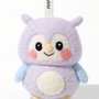 Front view of a handmade Woobbi owl keychain, crafted from soft lavender wool felt. The owl features large black eyes, rosy pink cheeks, a small yellow beak, and a cream-colored belly patch. It has light blue wings and is attached to a black metal keyring with a white tag labeled 'Woobbi'. The background is plain white with soft studio lighting.